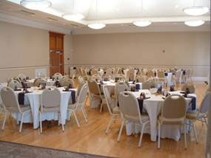 Meeting room with tables and chairs set up with tablecloths